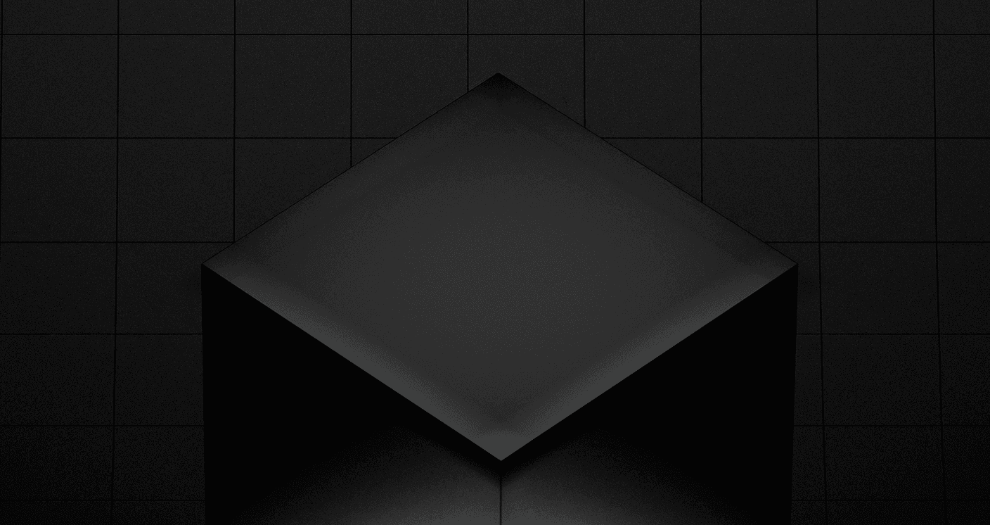 Un cubo geométrico de color negro mate se sitúa sobre un fondo de azulejos oscuros con iluminación suave y sombras sutiles. Esta imagen abstracta sirve como gráfico principal del motor de juegos Unity 7, y representa los gráficos 3D en tiempo real y el desarrollo de videojuegos.